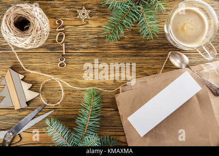 Packing a smartphone for a gift. The mess on the table. Place for text. The view from the top. Dark background, wood Stock Photo