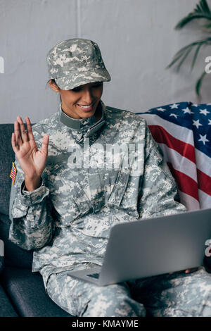 soldier making video call with laptop Stock Photo