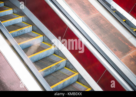 An empty moving escalator in subway. Escalator in metro. Moving up staircase. electric escalator. Selective soft focus Stock Photo