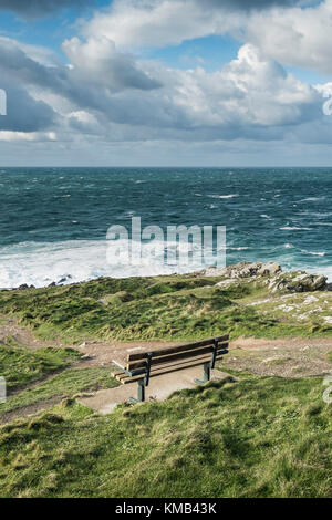 An empty bench seat overlooking the sea on Towan Headland in Newquay Cornwall. Stock Photo