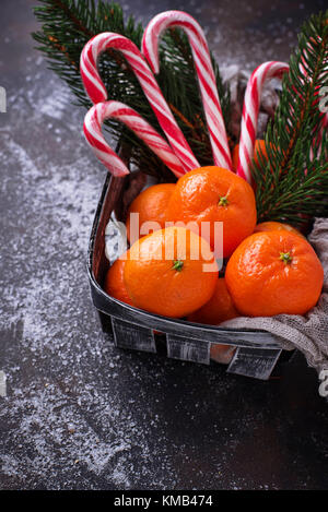 Tangerines and candy cane. Christmas background Stock Photo