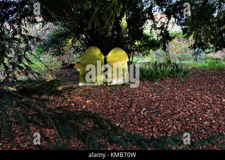 Old English cemetery with old gravestones and lots of undergrowth classic spooky style Stock Photo