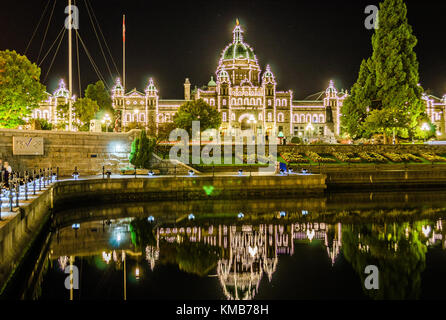 Illuminated Parliamnent House, Victoria, Canada,. Illuminations are reflected in the harbour waters Stock Photo