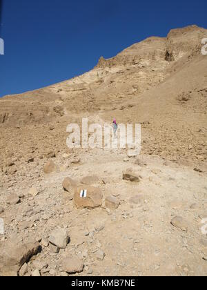 a hiking child going uphill a mountain Stock Photo