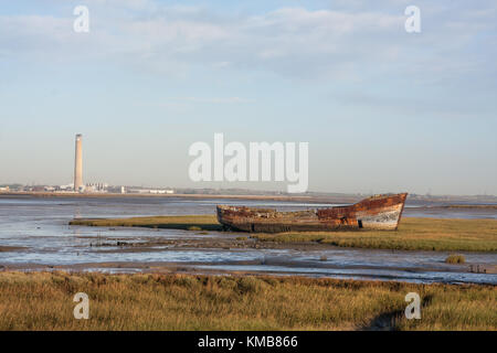 A discarded river goods transport barge on the swale estuary UK Stock Photo