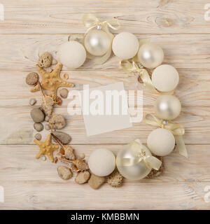 Christmas and New Year. Christmas wreath of Christmas-tree white toys in marine style, shells, stones and starfish. Selective focus. Stock Photo
