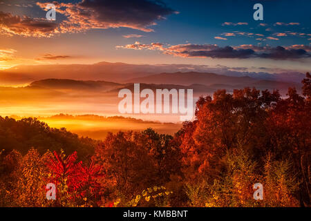 Colors of a brilliant sunrise over the mist shrouded mountains and ridges of the Great Smoky Mountain as seen from the Foothills Parkway West Stock Photo