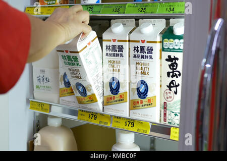 Taipei, Taiwan - October 19, 2017 : Woman selecting milk in grocery store diary and forzen department Stock Photo