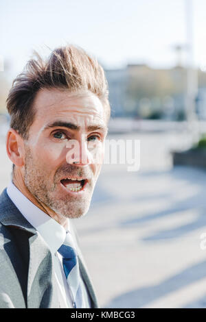 head portrait of a businessman who looks surprised in the camera Stock Photo