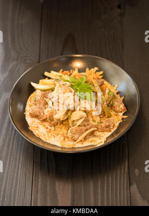 beef stroganoff  in black plate of beef ,mushroom and onion in cream sauce Stock Photo