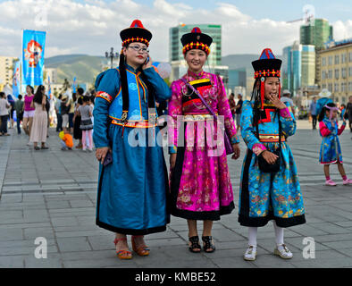 Three girls in traditional  festive garment  at the Mongolian National Costume Festival, Ulaanbaatar, Mongolia Stock Photo