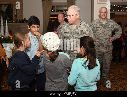 Lt Gen John Thompson, Commander, Space and Missile Systems Center, BGen Philip Garrant, Vice Commander, SMC, and Col Charles Roberts Commander, 61st Air Base Wing, meet with kids during the holiday event. Family, friends, and base housing residents were treated to food snacks, toys, crafts, and a visit with Santa in the Community Center to get the holiday spirit going. Earlier in the evening the 61st Air Base Group Commander, Col Charles Roberts, along with some of his little helpers, flipped the switch to light the Christmas tree, near the parade grounds on Fort MacArthur, San Pedro, Californ Stock Photo