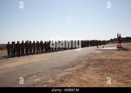 Paratroopers line up in formation to receive their foreign jump wings from the foreign jumpmasters after their descent onto Sicily Drop Zone on Fort Bragg, North Carolina.  Dec. 01, 2017. ‘Jump day’ is the first of two days in the 20th Annual Randy Oler Memorial Operation Toy Drop, hosted by U.S. Army Civil Affairs & Psychological Operations Command (Airborne). Operation Toy Drop is the world’s largest combined airborne operation with nine partner nation paratroopers participating and allows Soldiers the opportunity to train on their military occupational specialty, maintain their airborne rea Stock Photo