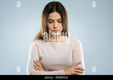 Thoughtful brunette girl looking downwards Stock Photo