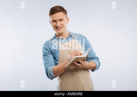 Delighted brunette making some notes Stock Photo