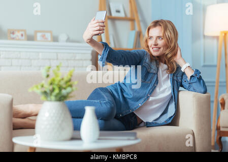 Positive smiling woman looking at the camera and posing for a photo Stock Photo