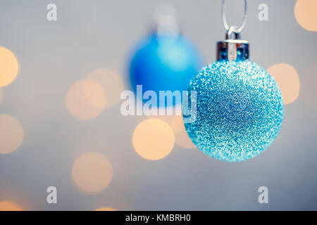 Image of two Christmas blue balls on gray background with spots. Stock Photo