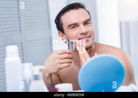 Cheerful glad man getting ready for work Stock Photo