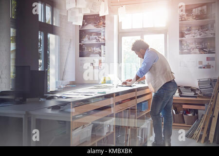 Graphic designer working at laptop in office Stock Photo