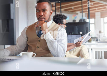 Serious,focused businessman working at computer in office Stock Photo