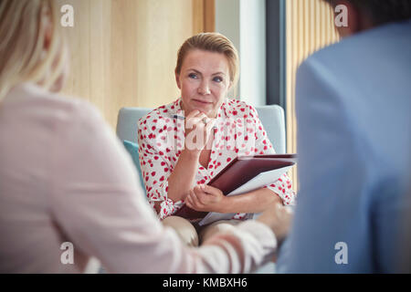 Therapist listening to couple in couples therapy counseling session Stock Photo