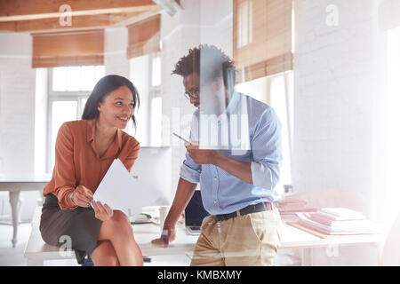 Business people discussing paperwork in office Stock Photo