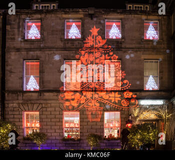 Christmas trees and snowflakes light projection onto the walls and windows of the Tigerlily restaurant in George Street, New Town, Edinburgh, Scotland Stock Photo