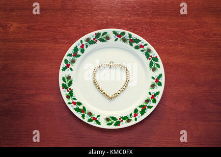 Close up of a plate with christmas decorations and with chocolate cookies in tree shape. Stock Photo