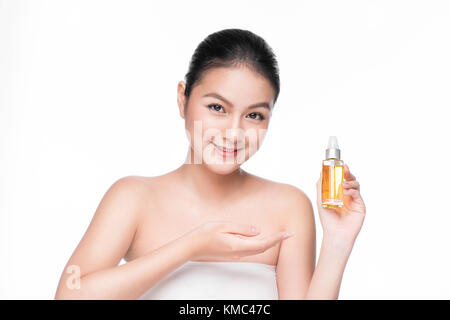 Health, spa and beauty concept. Asian woman with perfect skin holding oil bottle Stock Photo