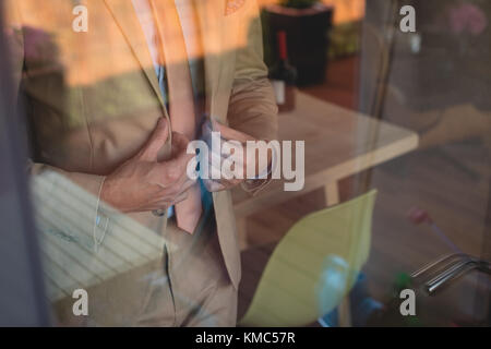 Man wearing his blazer at home Stock Photo