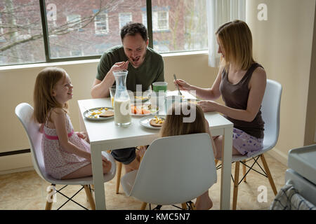 Family having breakfast in kitchen Stock Photo
