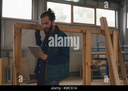 Carpenter using digital tablet Stock Photo