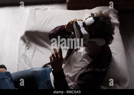 Man using virtual reality headset in living room Stock Photo