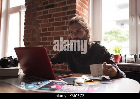 Male graphic designer working on laptop Stock Photo
