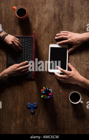 Male executives working on laptop and digital tablet Stock Photo