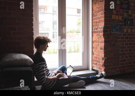 Male graphic designer using laptop Stock Photo
