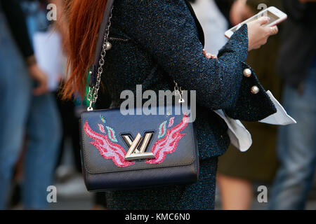 MILAN - SEPTEMBER 23: Woman with Louis Vuitton bag with red border