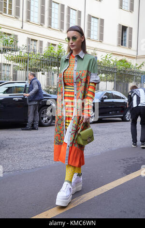 MILAN, ITALY - SEPTEMBER 23, 2022: Woman with orange cargo trousers and  white bra before Sportmax fashion show, Milan Fashion Week street style  Stock Photo - Alamy