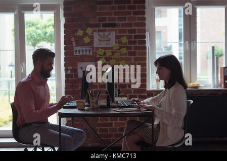 Executives working on computer Stock Photo