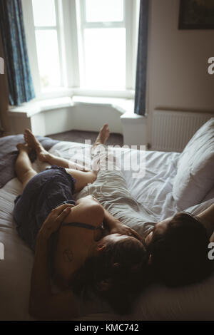 Couple sleeping together on bed in bedroom Stock Photo