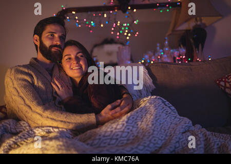 Happy couple relaxing on bed in bedroom Stock Photo