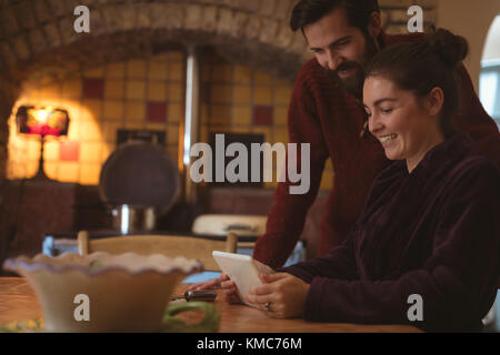 Couple having fun while using digital tablet Stock Photo