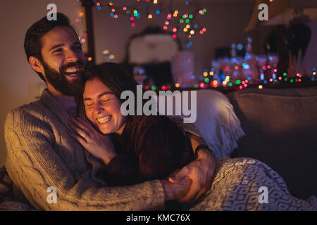 Couple having fun while relaxing on sofa Stock Photo