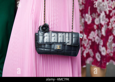 MILAN - SEPTEMBER 23: Woman with Chanel black leather bag with pink pleated  skirt before Ermanno Scervino fashion show, Milan Fashion Week street styl  Stock Photo - Alamy
