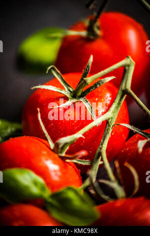 Cherry tomatoes on the vine Stock Photo
