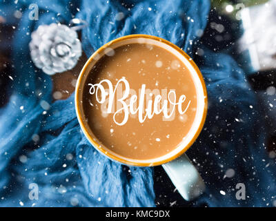 Mug of coffee and milk on dark blue winter background. Selective focus. Falling snow effect. Believe in your dreams concept Stock Photo