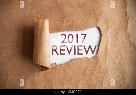 Torn piece of scroll uncovering 2017 review Stock Photo