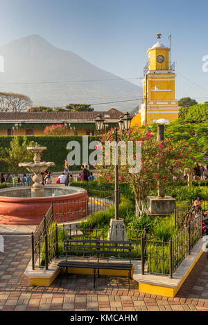 Town hall tower at the main square with view to the Agua volcano in the background | Ciudad Vieja Stock Photo