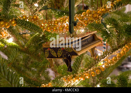 Grand piano Christmas ornament hanging from tree Stock Photo
