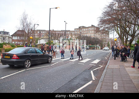 LONDON CITY - DECEMBER 25, 2016: People stopping traffic by walking on the crossing over Abbey Road like the cover from the Beatles Stock Photo